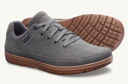 This is a men's casual sneaker with a grey suede upper and a tan-brown rubber sole. It features a lace-up design, low profile silhouette, and visible stitching along the upper. Notable attributes include the soft suede material, grey color, and the contrasting brown outsole for a rounded, everyday-look sneaker.