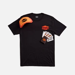 A black short-sleeve t-shirt with bold orange branding. The look is casual/unisex streetwear, featuring an orange Brunt logo graphic on the chest and a matching bright-orange cap shown alongside, plus a fan of playing cards and small accessory graphics. Visible material appears to be cotton; the color palette is black with vivid orange accents and white card imagery.