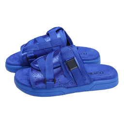 These are cobalt-blue open-toe platform sandals with multiple woven fabric straps and a cushioned, contoured footbed. The styling reads as sporty, unisex casualWear, suitable for warm-weather outfits. Notable materials include blue fabric straps and a matching blue foam/sole with a subtle wavy tread pattern.