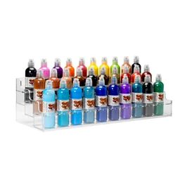 A clear acrylic three-tier countertop rack holding rows of colourful 4oz tattoo ink bottles on a white background.