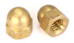 Two brass dome-shaped hex cap nuts with threaded openings shown on a plain white background, one standing upright and one lying on its side.