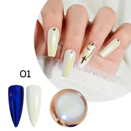 Pearlescent white nail powder in a round gold-rimmed jar beside two swatch nails, one deep blue and one pale iridescent white, with a hand wearing pearly white nails with a cross charm.