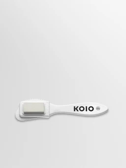 Side view of Koio Suede Brush showcasing its cleaning head and KOIO branded handle on a white background