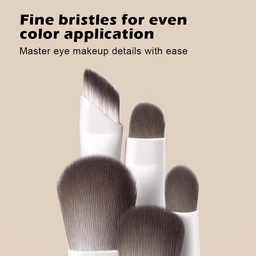 A white eyeshadow makeup brush with dark brown bristles and a small rounded tip, set against a beige background with overlaid promotional text.