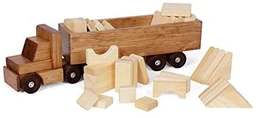 A brown wooden toy semi truck with an attached open-top trailer, surrounded by unfinished pale wood building blocks and ramp pieces on a white background.