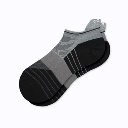 These are low-cut running ankle compression socks in a gray and black color-block design with reinforced heel and toe. The knit shows breathable mesh panels and structured compression zones around the arch and ankle, suggesting a snug, supportive fit. Overall, a unisex style suitable for runners, with a sporty, technical look.