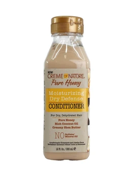 A clear plastic bottle of cream-coloured hair conditioner with a gold cap, labelled Creme of Nature Pure Honey Moisturizing Dry Defense Conditioner, shown against a plain white background.
