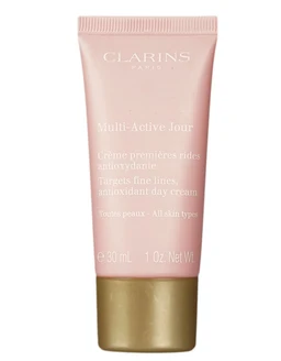 A pink plastic tube of Clarins Multi-Active Jour day cream with a gold cap, shown against a white background.