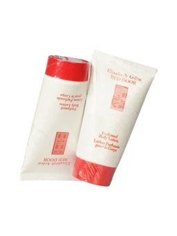 Two white tubes of Elizabeth Arden Red Door perfumed body lotion with red caps and red and white labeling, one tube wrapped in clear plastic, shown on a white background.