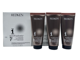 A white retail box labelled Redken Smooth Activator Step 1 sits beside three dark brown tubes of hair product, each with a silver cap, on a plain white background.