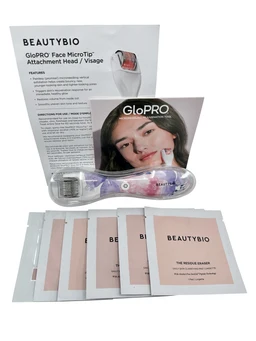 A lavender floral-patterned handheld facial microneedling roller with a silver microneedle head, shown beside a GloPro instruction card, a face-attachment head package, and several pink residue eraser and skin prep pad sachets on a white background.
