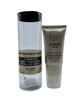 A clear cylindrical tube packaging with a black cap and a beige-gold plastic tube with a white and gold label, both displayed against a plain white background showing the blonde root concealer product.