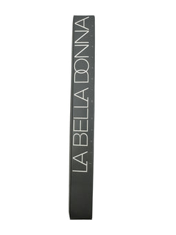 A tall, narrow dark grey box standing upright with the white serif wordmark LA BELLA DONNA printed vertically along its front face.