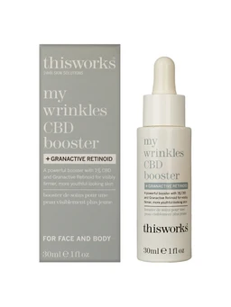 A white dropper bottle of serum stands beside a grey and white box, both labelled ThisWorks My Wrinkles CBD Booster with a 30ml size, against a plain white background.