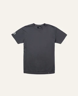 A plain, charcoal gray short-sleeve tee with a classic crew neck. The fit appears basic and unisex, suitable for layering or casual wear. Visible details include a small brand-like tag at the bottom hem and a light graphic/text on the left sleeve.