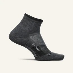 This is a mid-weight athletic quarter-length sock in dark heather gray. It features a cushioned footbed with a black arch-support band and reinforced heel and toe for durability. The knit shows ribbed ankle cuff and subtle contrast panels, giving it a performance-focused, unisex athletic style.